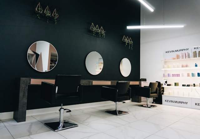 Modern salon interior with styling chairs, mirrors, and product displays